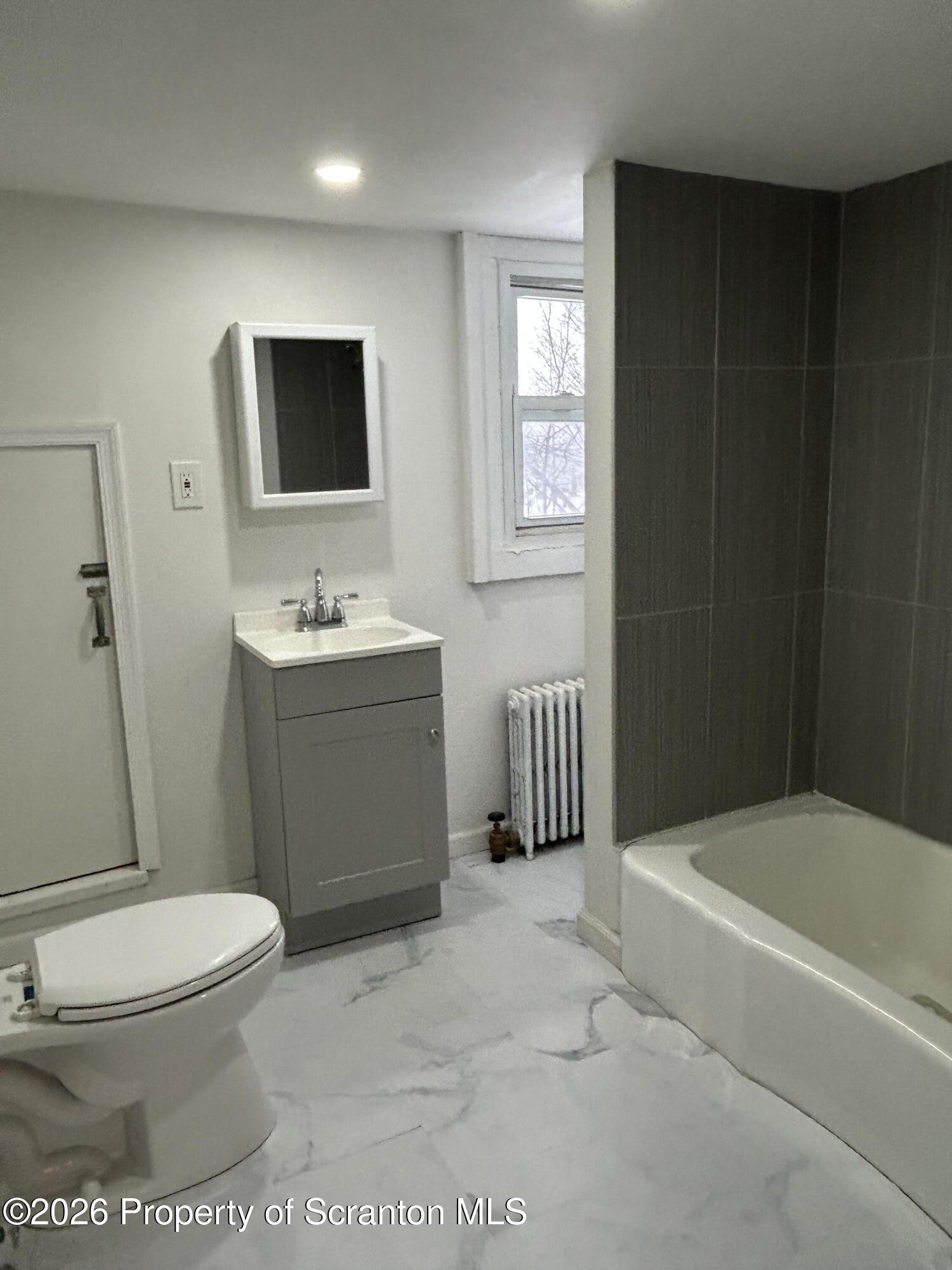 337 Wayne Street Archbald, PA 18403 - Photo 23 of 26 a bathroom with a toilet sink and mirror