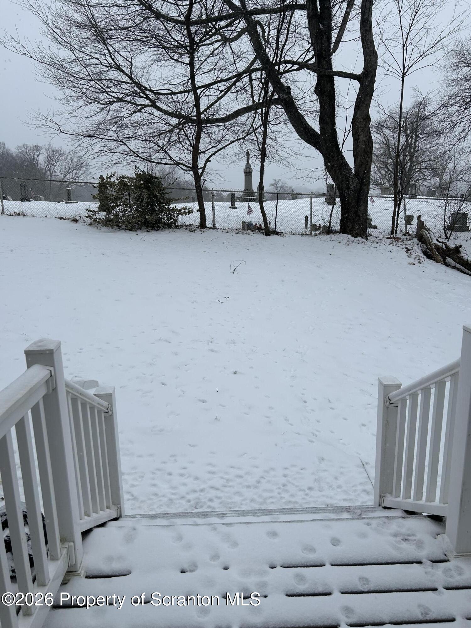 337 Wayne Street Archbald, PA 18403 - Photo 6 of 26 a view of backyard with large trees and wooden fence