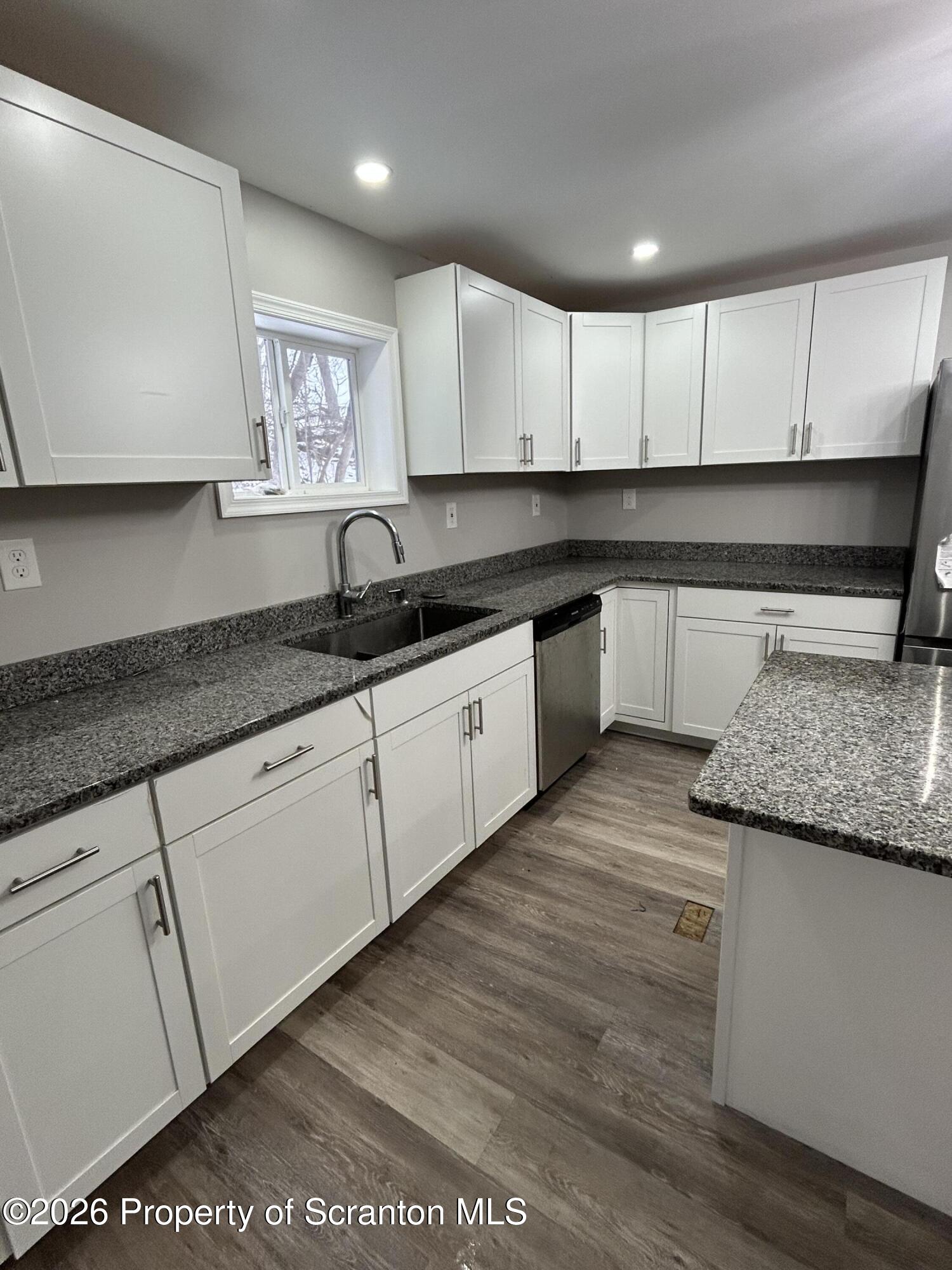337 Wayne Street Archbald, PA 18403 - Photo 7 of 26 a kitchen with granite countertop a sink and cabinets
