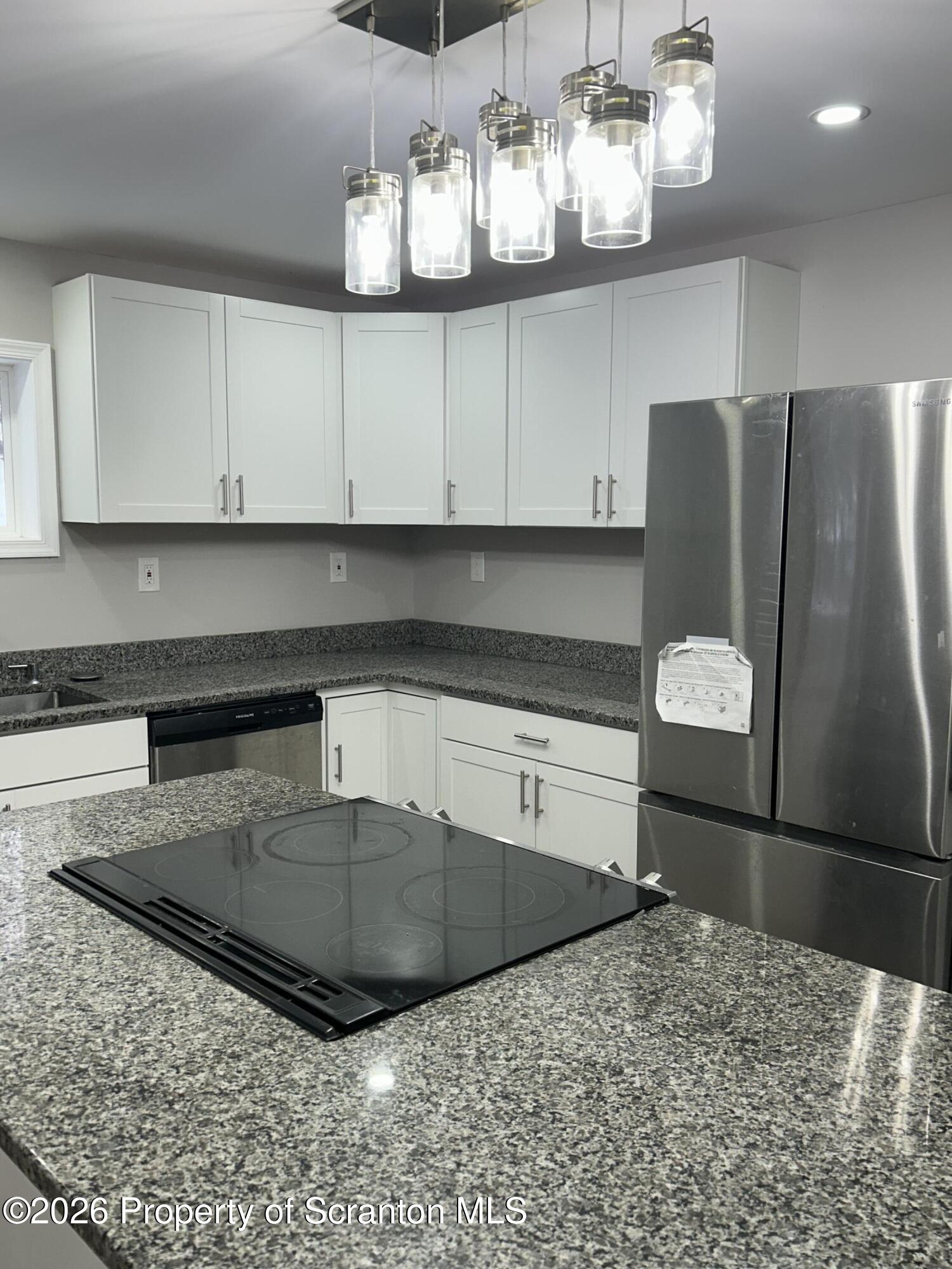 337 Wayne Street Archbald, PA 18403 - Photo 10 of 26 a kitchen with stainless steel appliances granite countertop a sink a stove and a refrigerator