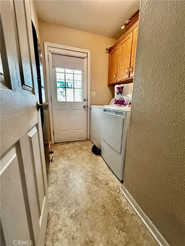 a utility room with sink dryer and washer