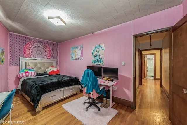 a bedroom with a bed and a desk