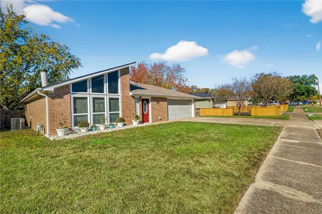 a view of a house with backyard and a tree
