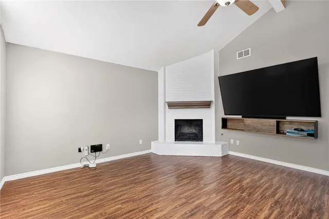 a view of a livingroom with wooden floor and a flat screen tv