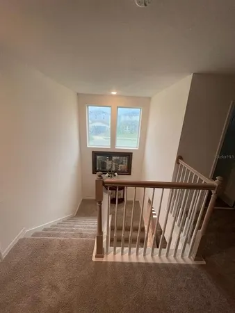 a view of staircase with wooden floor