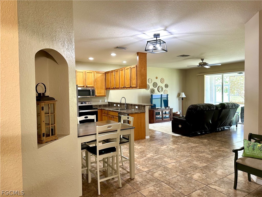 14122 Danpark Loop Fort Myers, FL 33912 - Photo 2 of 15 a large kitchen with a table and chairs