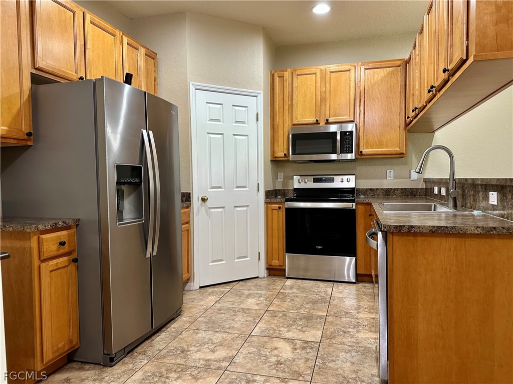 14122 Danpark Loop Fort Myers, FL 33912 - Photo 3 of 15 a kitchen with stainless steel appliances granite countertop a refrigerator stove and sink