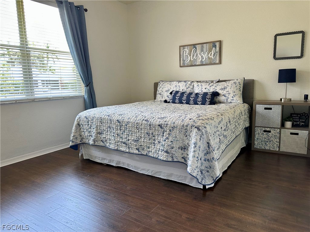 14122 Danpark Loop Fort Myers, FL 33912 - Photo 4 of 15 a bedroom with a bed and a window