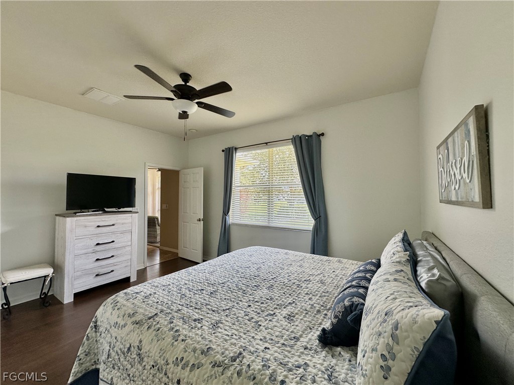 14122 Danpark Loop Fort Myers, FL 33912 - Photo 5 of 15 a bedroom with a bed and a flat screen tv