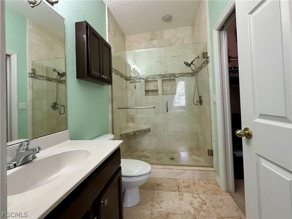 14122 Danpark Loop Fort Myers, FL 33912 - Photo 6 of 15 a bathroom with a sink a toilet and shower