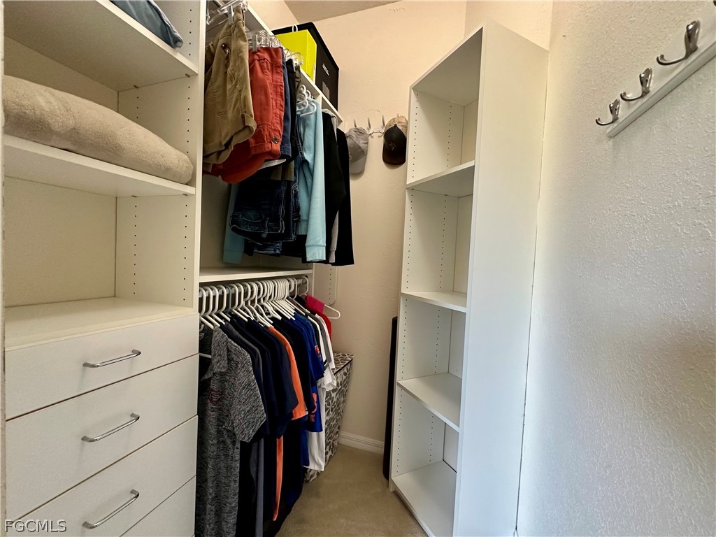 14122 Danpark Loop Fort Myers, FL 33912 - Photo 7 of 15 a view of walk in closet with clothes and shoes