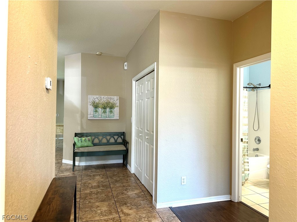 14122 Danpark Loop Fort Myers, FL 33912 - Photo 9 of 15 a view of a hallway with wooden floor and a bathroom