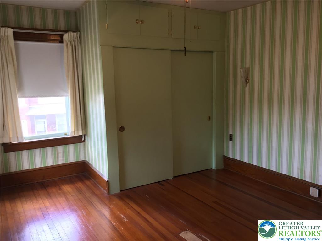 1105 Main Street Slatington, PA 18080 - Photo 20 of 31 Natural wood floors and trim complement this room, featuring a convenient built-in closet and storage.