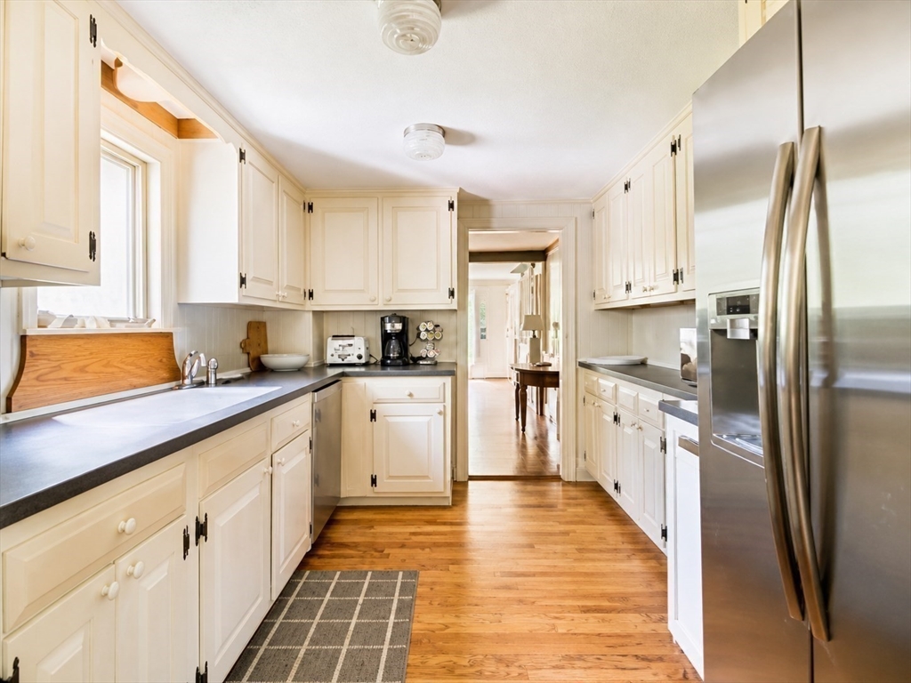 60 Rock Harbor Road Orleans, MA 02653 - Photo 11 of 37 a kitchen with stainless steel appliances a refrigerator sink and cabinets