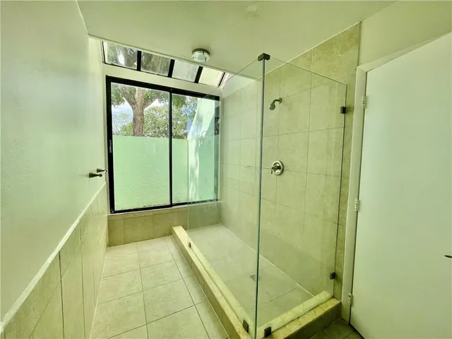 a bathroom with a granite countertop toilet sink and mirror