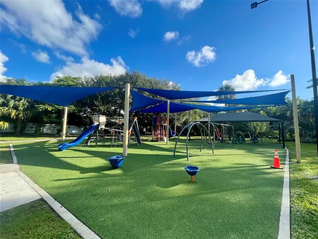 a view of a park with plants and a tree