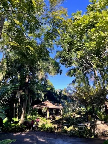 a sign that is in front of flowers