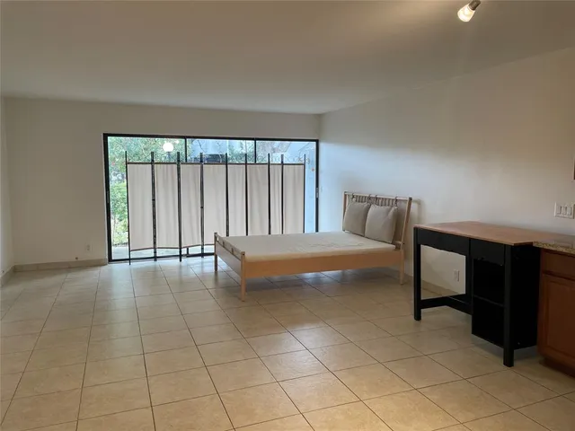 a bedroom with a bed and glass window
