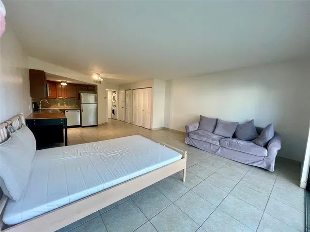 a kitchen with a refrigerator and a stove top oven