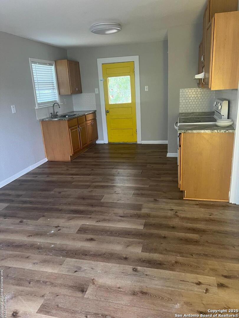 1519 East Southcross, Unit 1 San Antonio, TX 78223 - Photo 3 of 9 a view of a room with wooden floor and chair