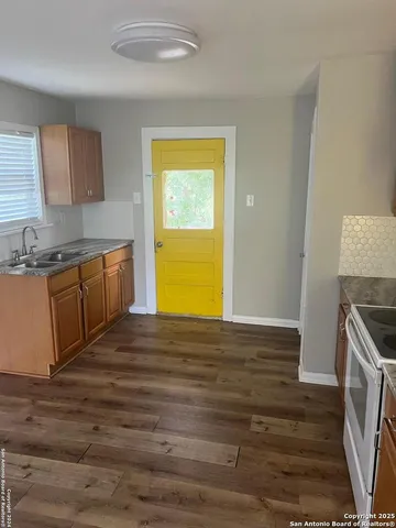 a kitchen with stainless steel appliances wooden cabinets and a sink