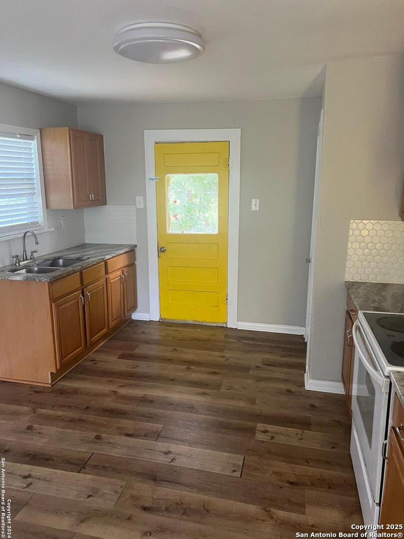 1519 East Southcross, Unit 1 San Antonio, TX 78223 - Photo 7 of 9 a view of a kitchen with wooden floor and a sink