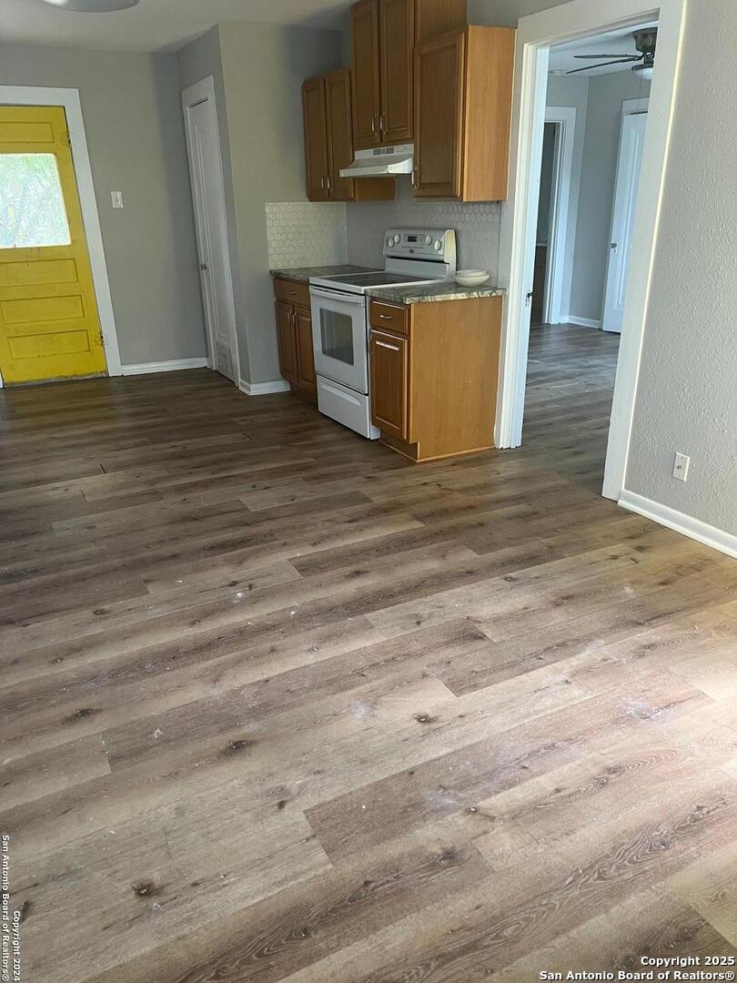 1519 East Southcross, Unit 1 San Antonio, TX 78223 - Photo 8 of 9 a kitchen with stainless steel appliances wooden cabinets and a sink