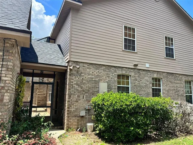 a garden with trees in front of it