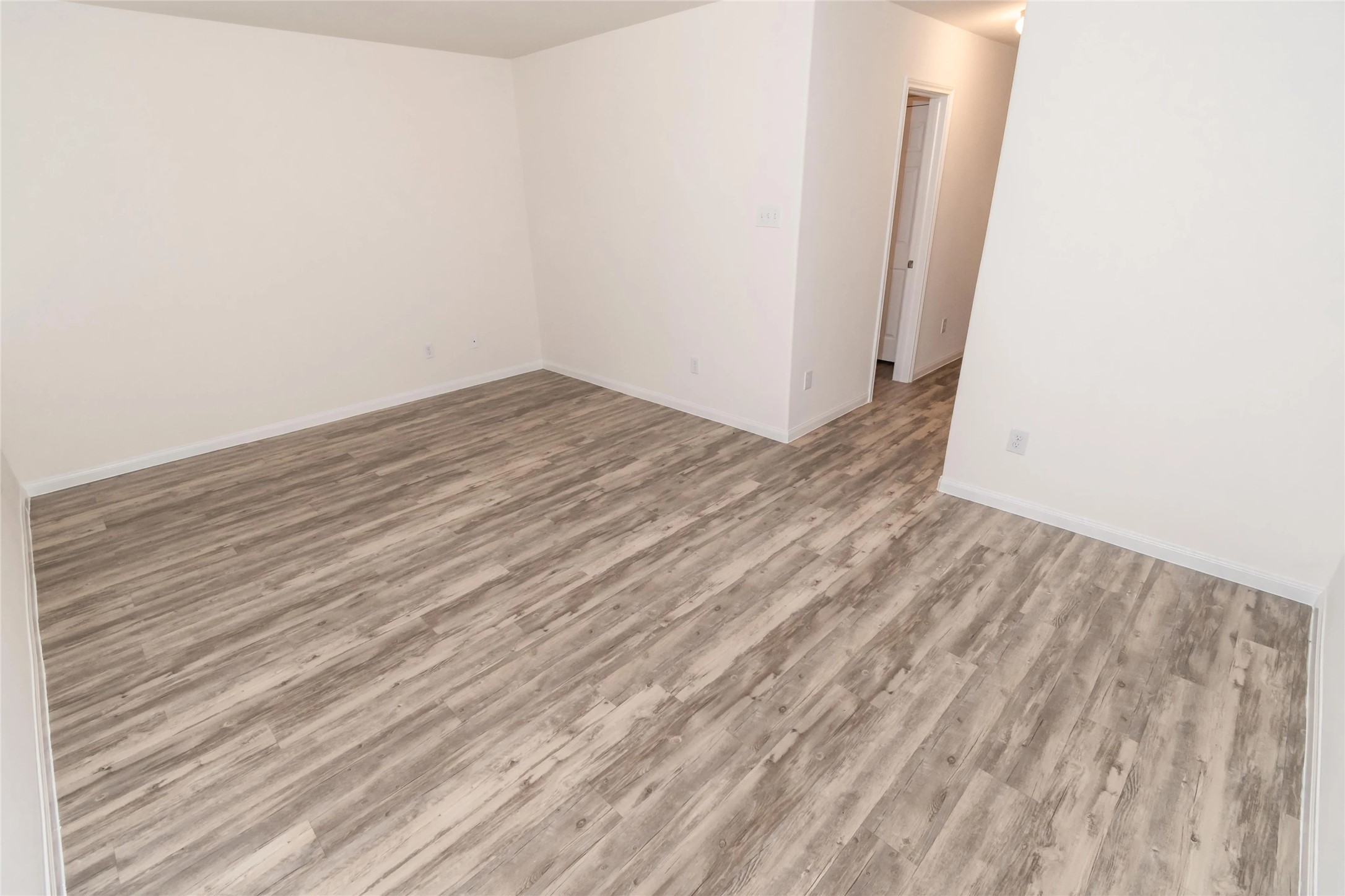 3030 Junction Drive Houston, TX 77045 - Photo 4 of 8 a view of empty room with wooden floor