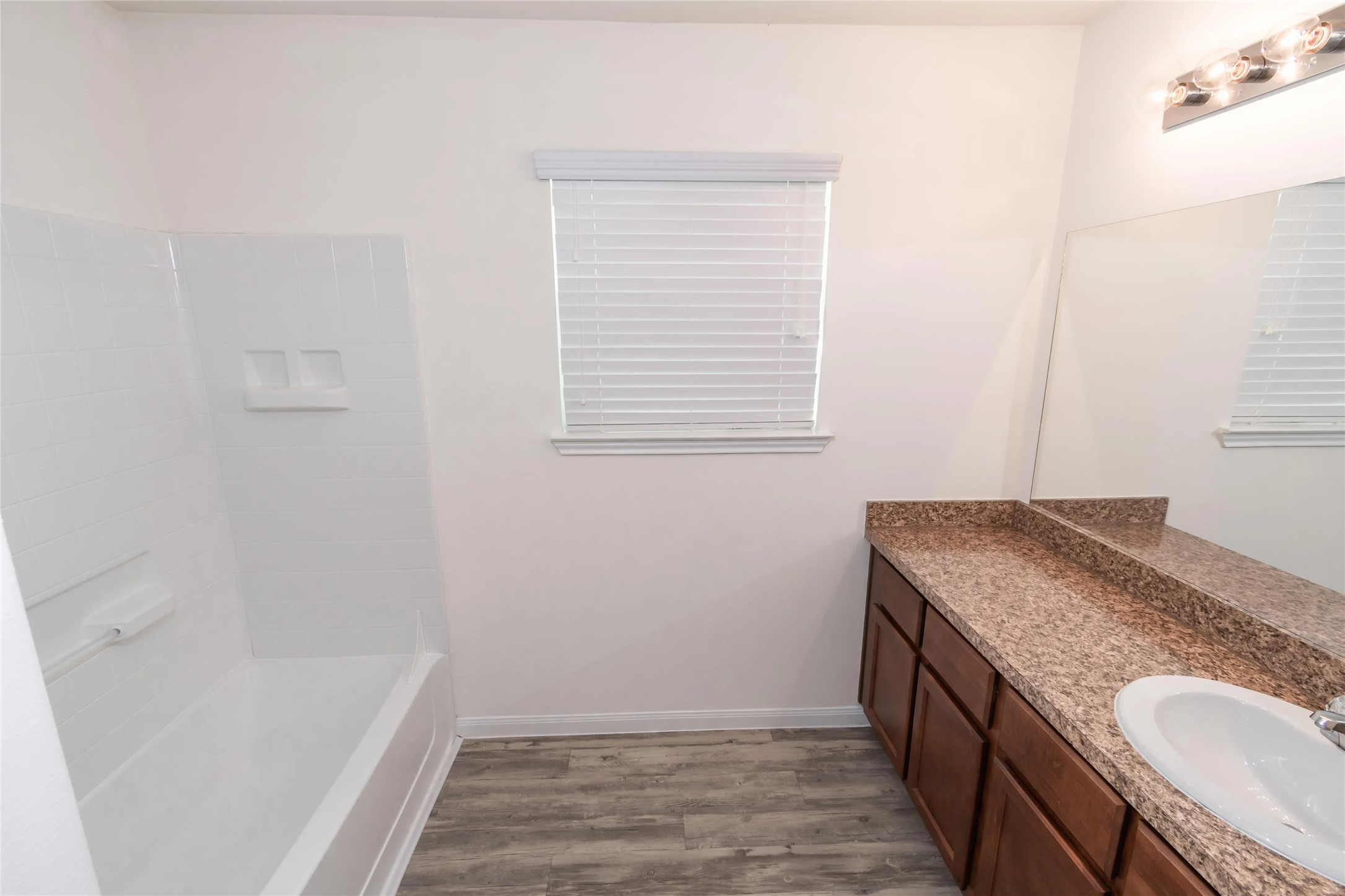 3030 Junction Drive Houston, TX 77045 - Photo 7 of 8 a bathroom with a granite countertop sink toilet and bathtub