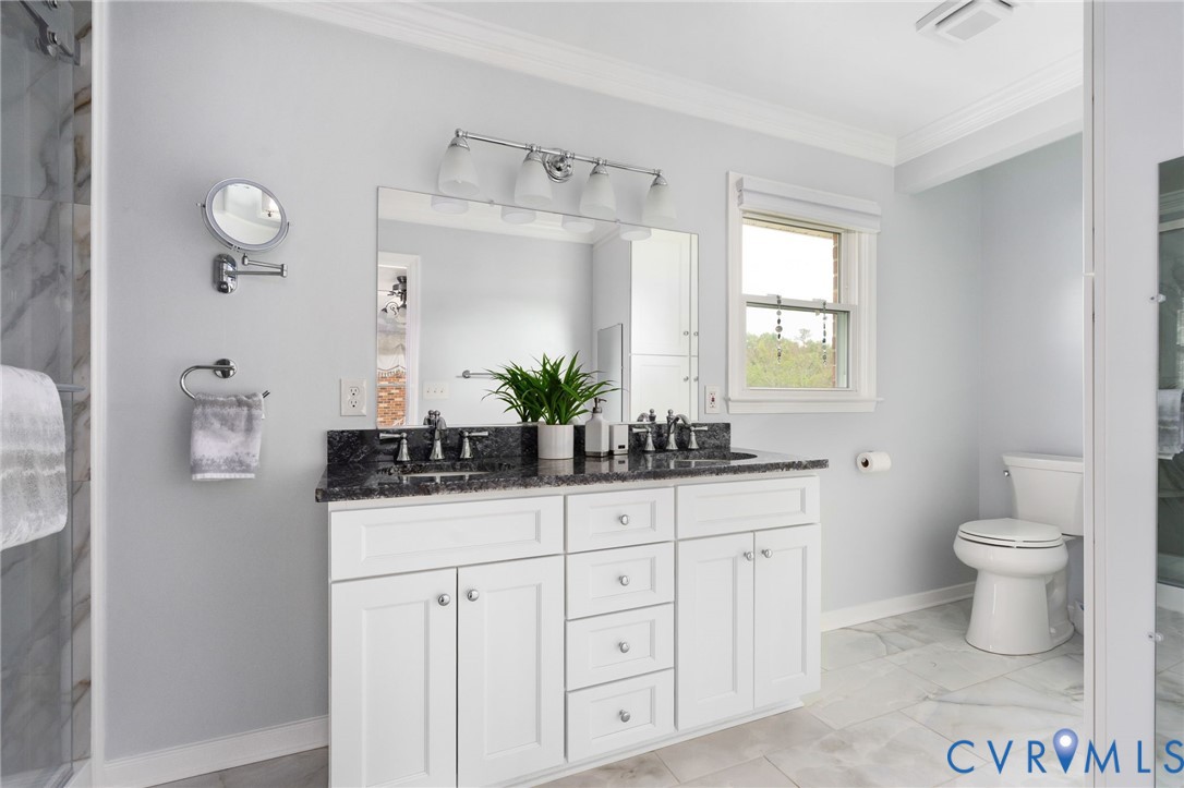 16379 Arch Hill Road Hanover, VA 23069 - Photo 19 of 26 a bathroom with a granite countertop sink a toilet and a large mirror