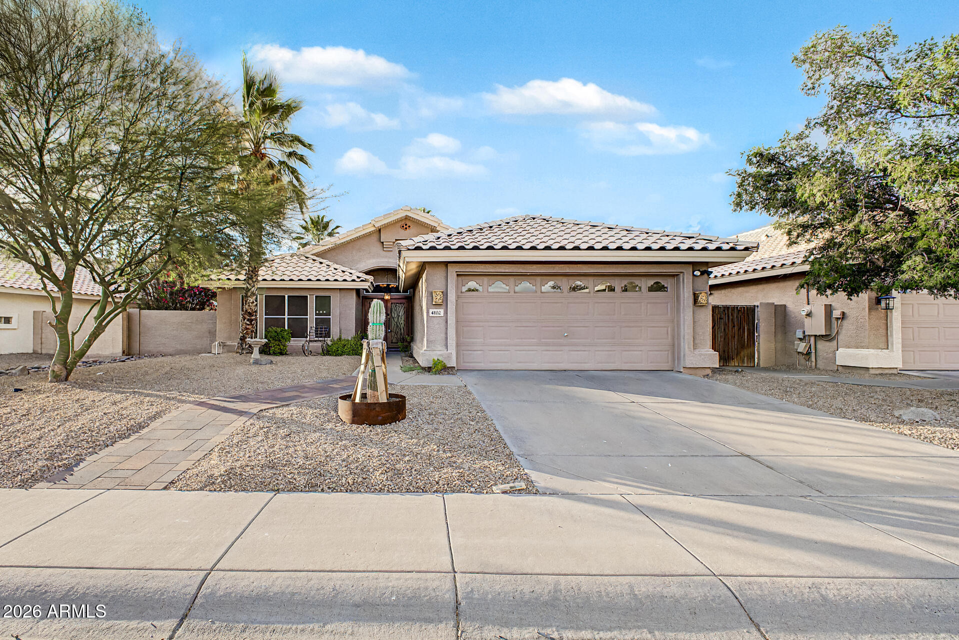 4102 East Rock Wren Road Phoenix, AZ 85044 - Photo 2 of 25 a front view of a house with garden