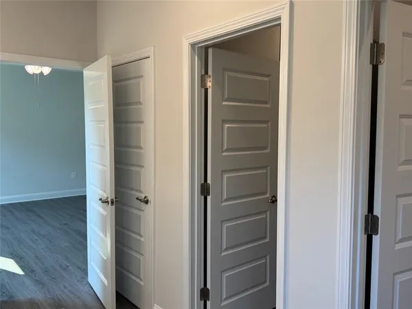 a view of elevator with hallway and wooden floor