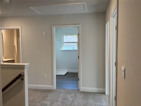 a view of an empty room with a fireplace and a window