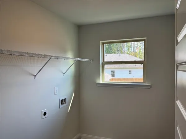 a bathroom with a window and a shower