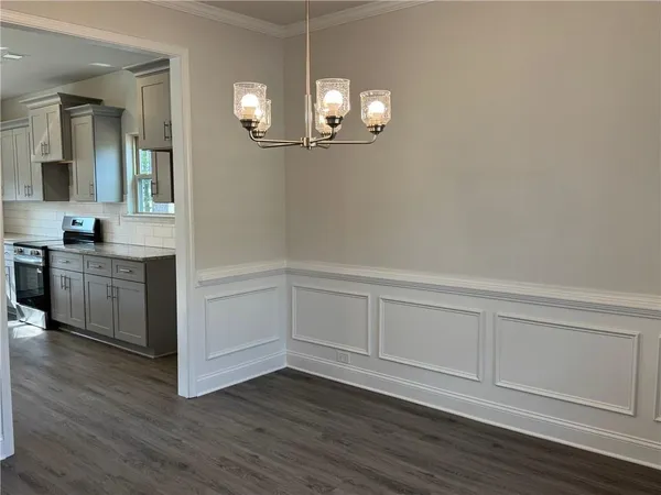 a view of a kitchen with wooden floor and cabinets