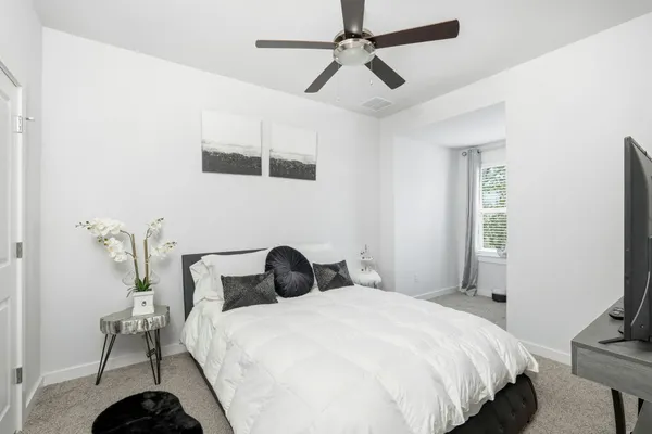 a bedroom with a bed and a chandelier