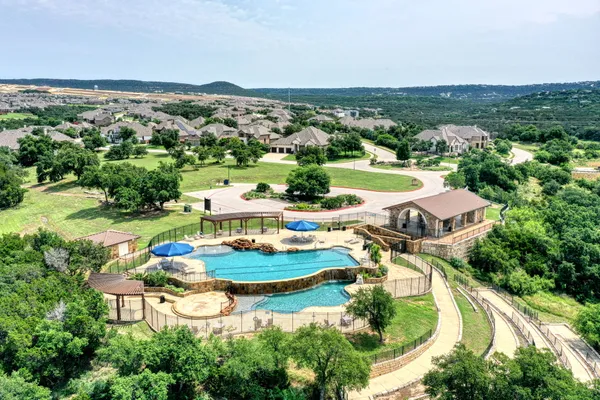 an aerial view of a house with a garden and lake view