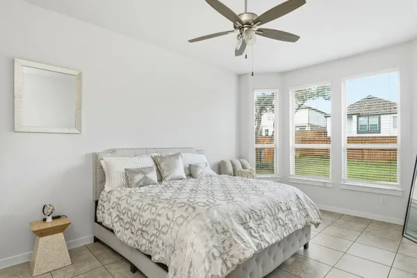 a bedroom with a large bed and a large window