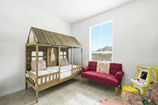a bedroom with furniture and a window