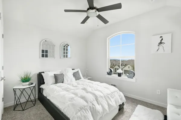 a bedroom with a bed and a painting on the wall