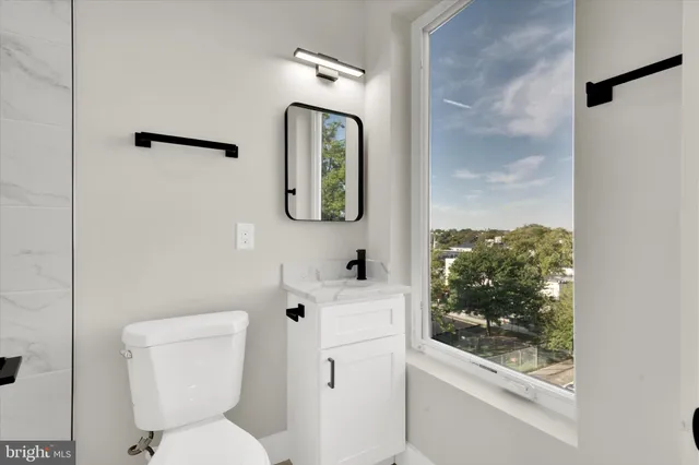 a white toilet sitting next to a bathroom sink