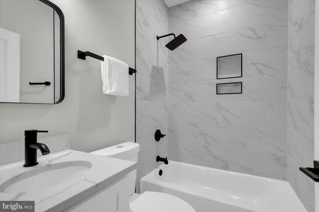 a bathroom with a sink a toilet and a bathtub