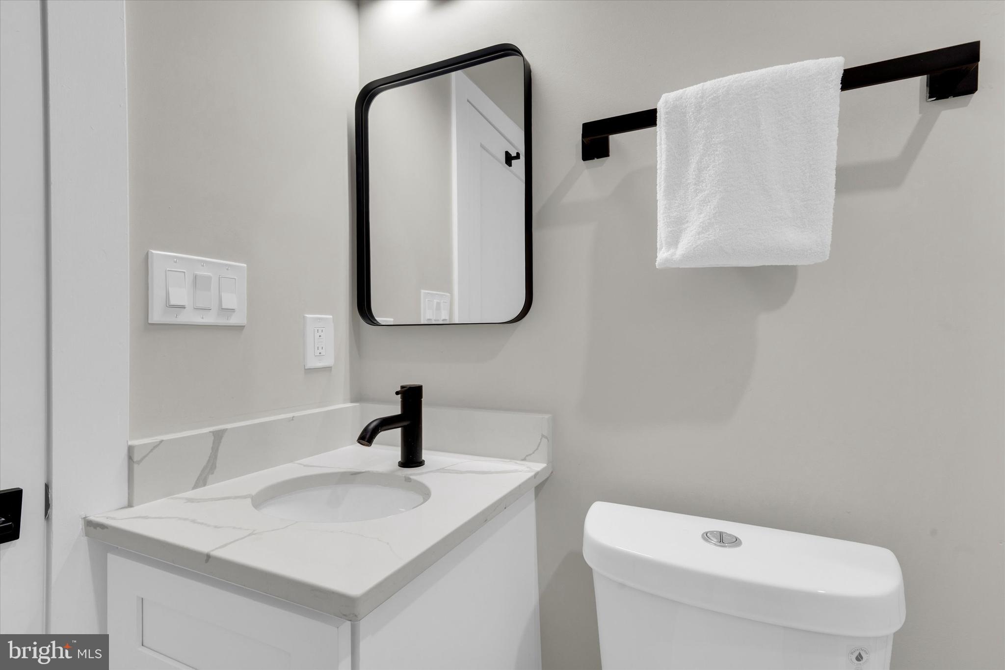 1915 Benning Road Northeast, Unit PH9 Washington, DC 20002 - Photo 17 of 20 a bathroom with a toilet sink and mirror