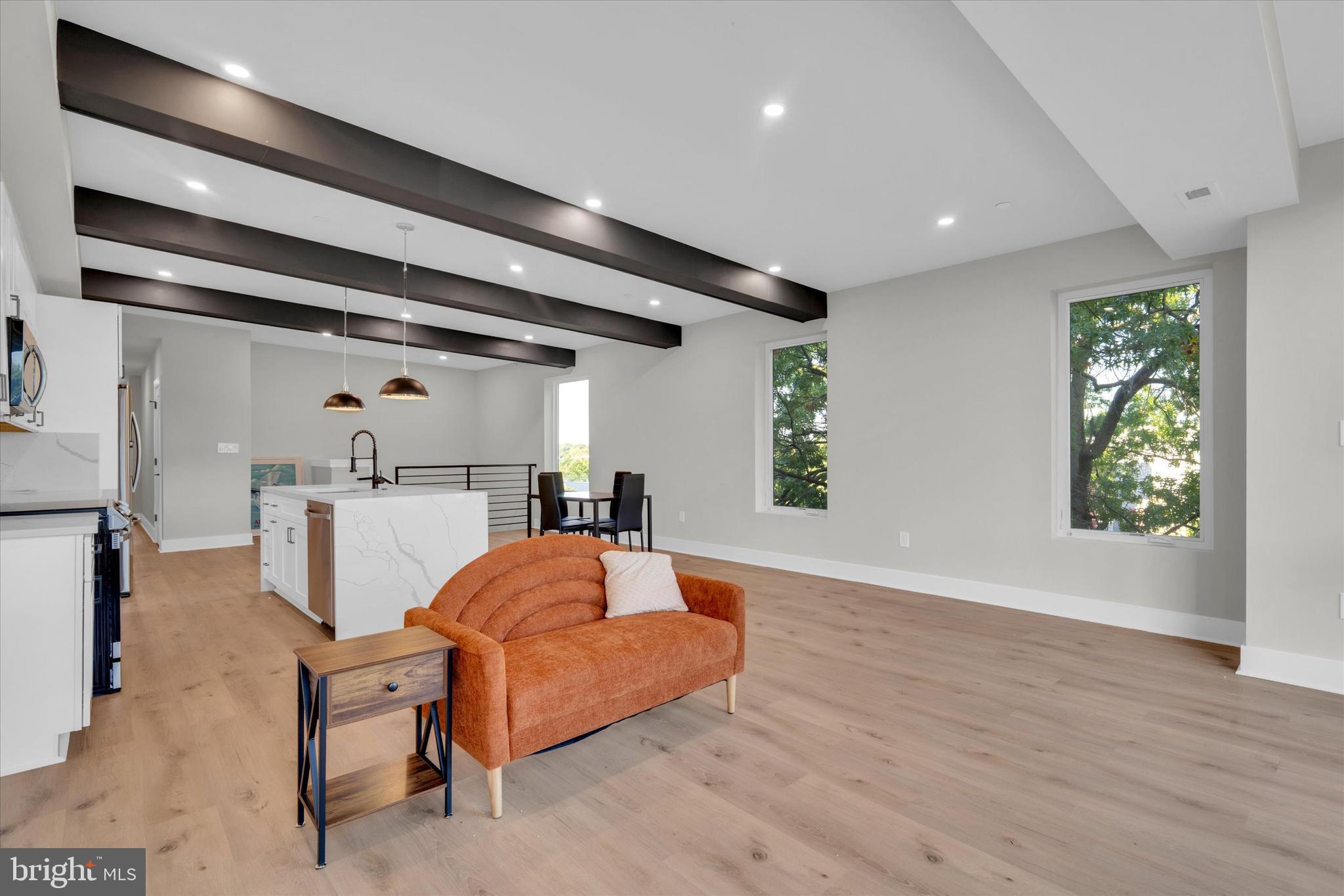 1915 Benning Road Northeast, Unit PH9 Washington, DC 20002 - Photo 5 of 20 a living room with furniture and a large window
