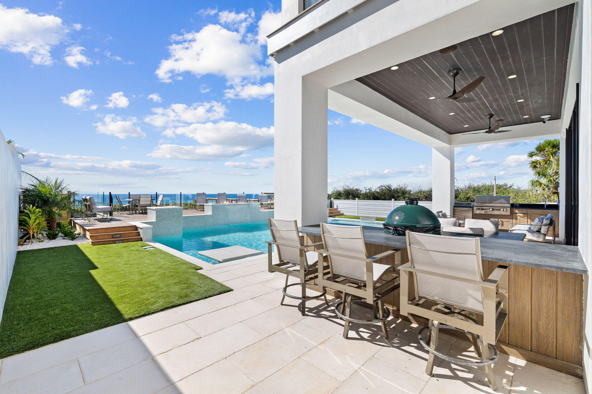 3504 East County Highway 30A Santa Rosa Beach, FL 32459 - Photo 134 of 137 a view of a patio with dining table and chairs with a yard