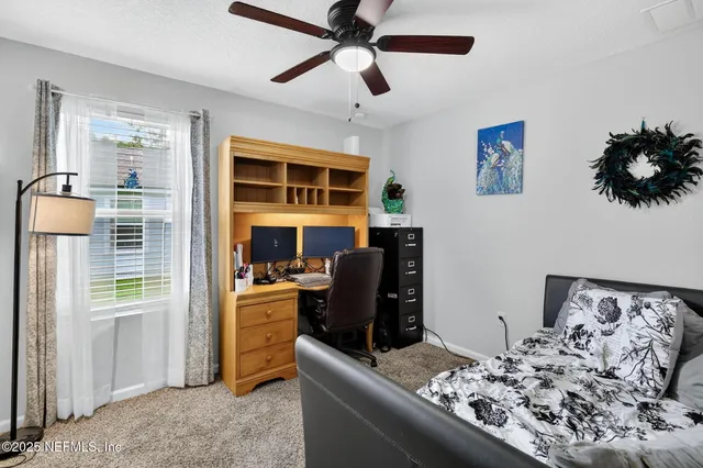 a bedroom with furniture and a window