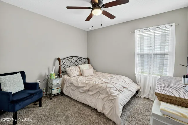 a bedroom with a bed and cabinet