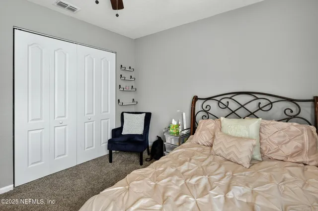 a bedroom with a bed and a television