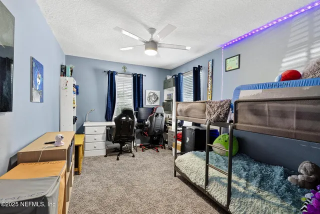 a bedroom with a bed and flat screen tv